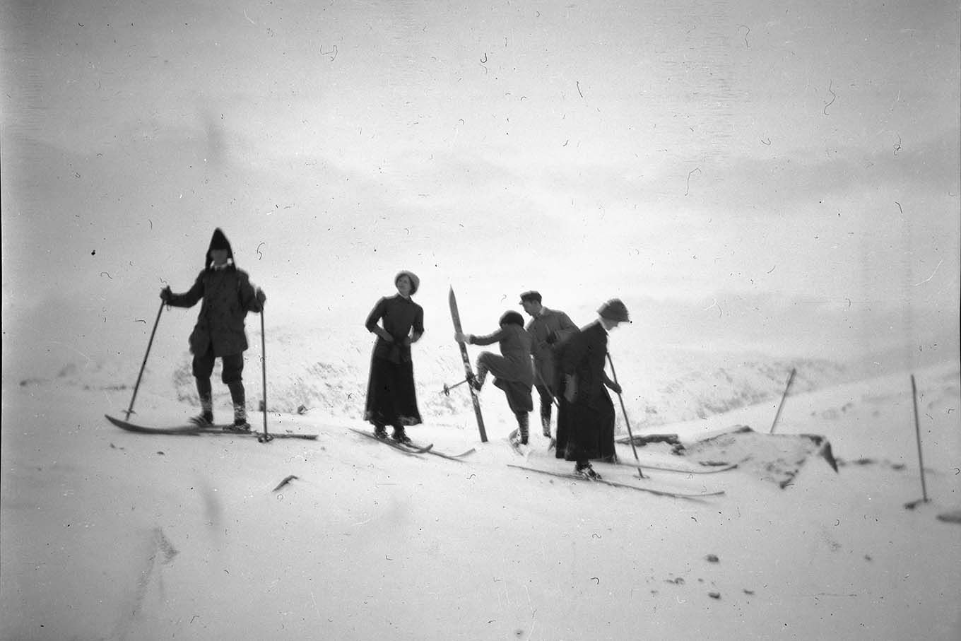 Tre menn og to kvinner på ski i fjellet. Foto.