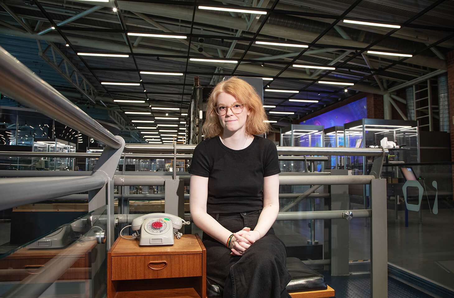 Master's student at a telephone in The Norwegian Museum of Science and Technology 's ICT exhibition I/O