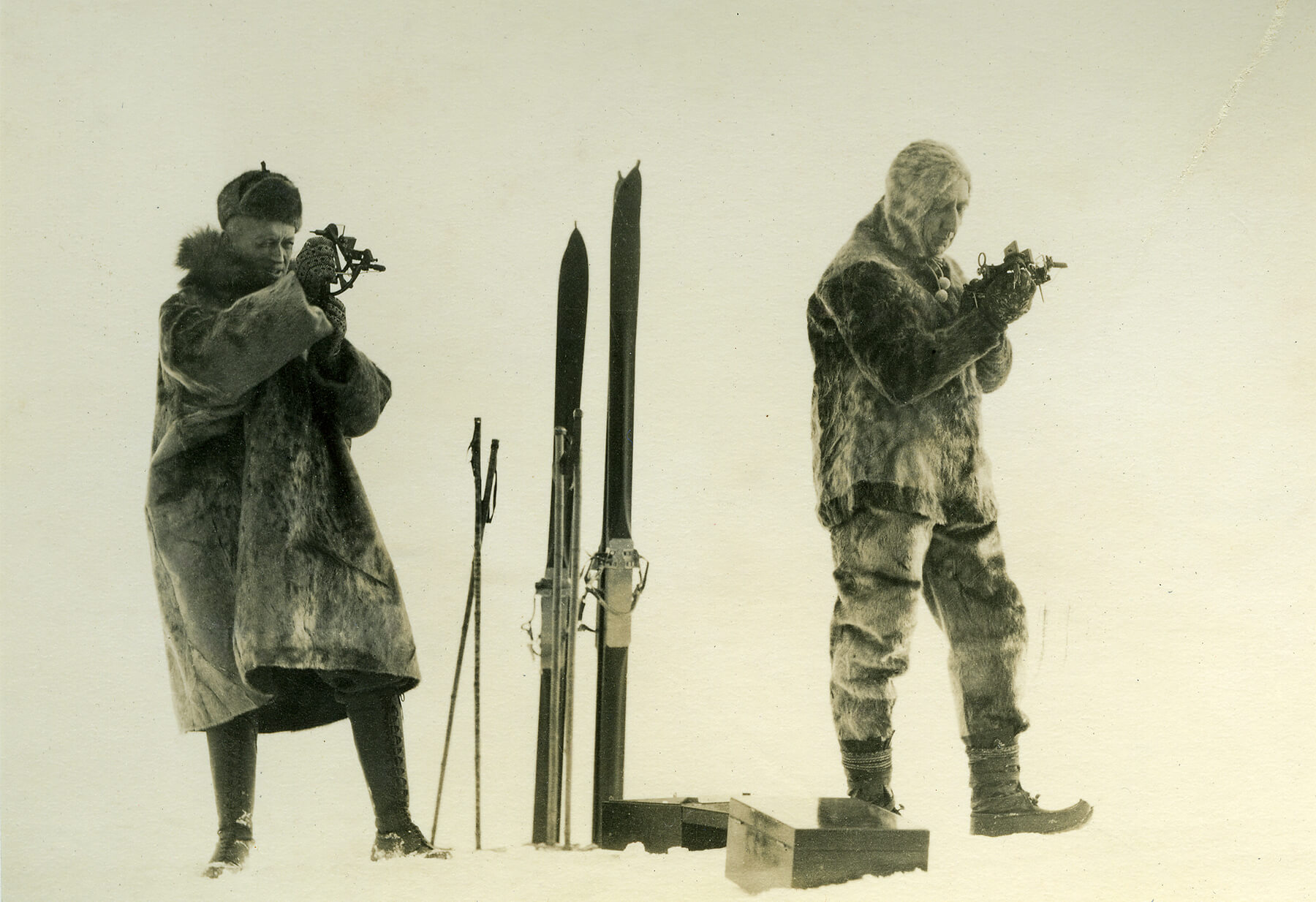 Lincoln Ellsworth og Roald amundsen i skinnklær med ski i vinterlandskap