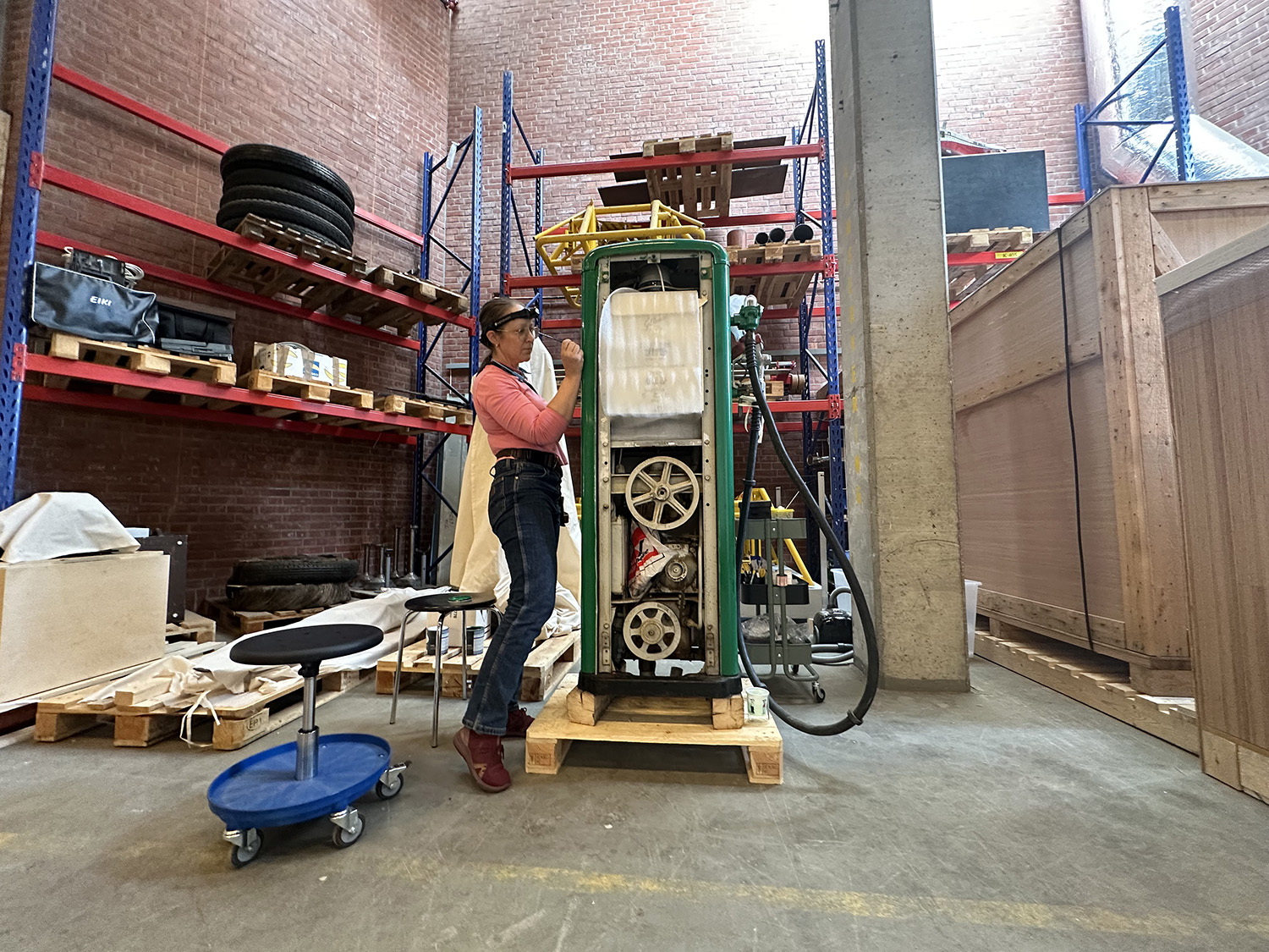 Woman restoring an old fuel pump