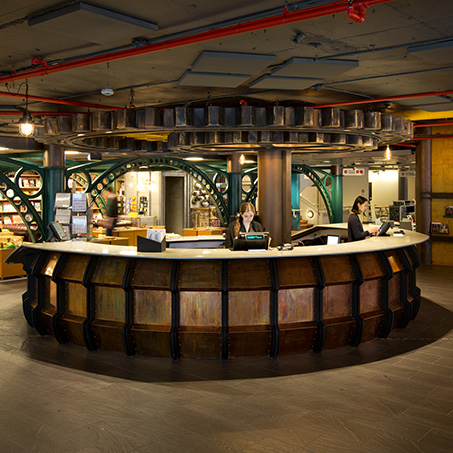 Large round reception desk in front of a shop.