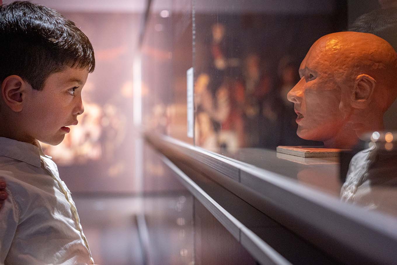 Picture of boy looking at sculpture abstract feeling