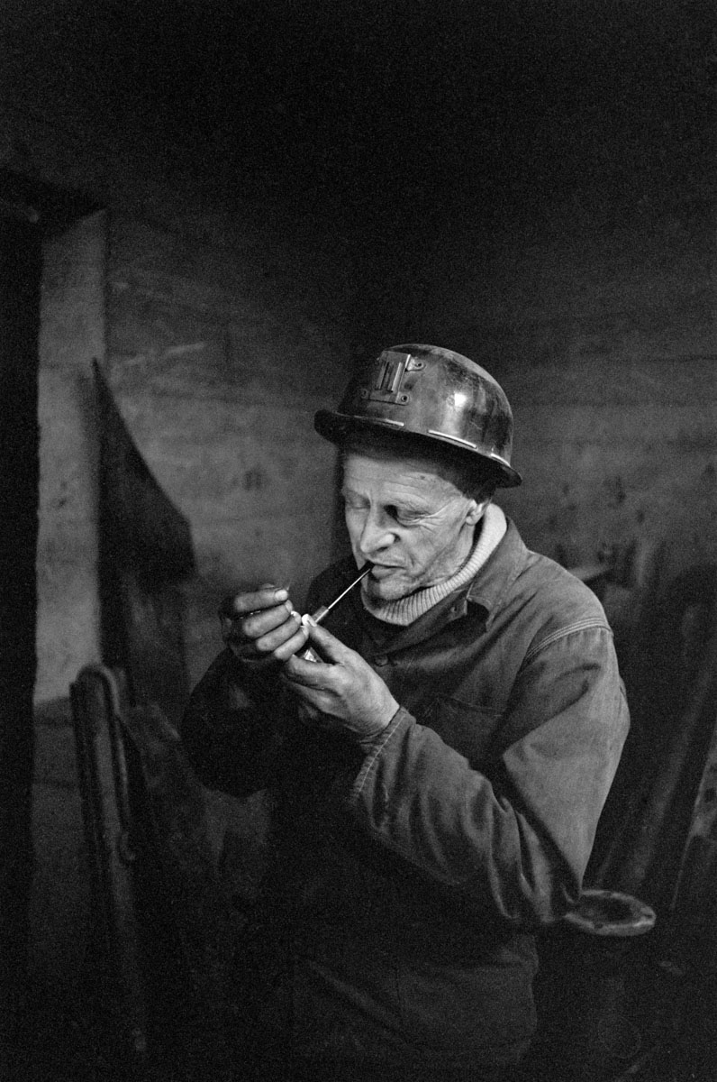 miner lights a cigarette