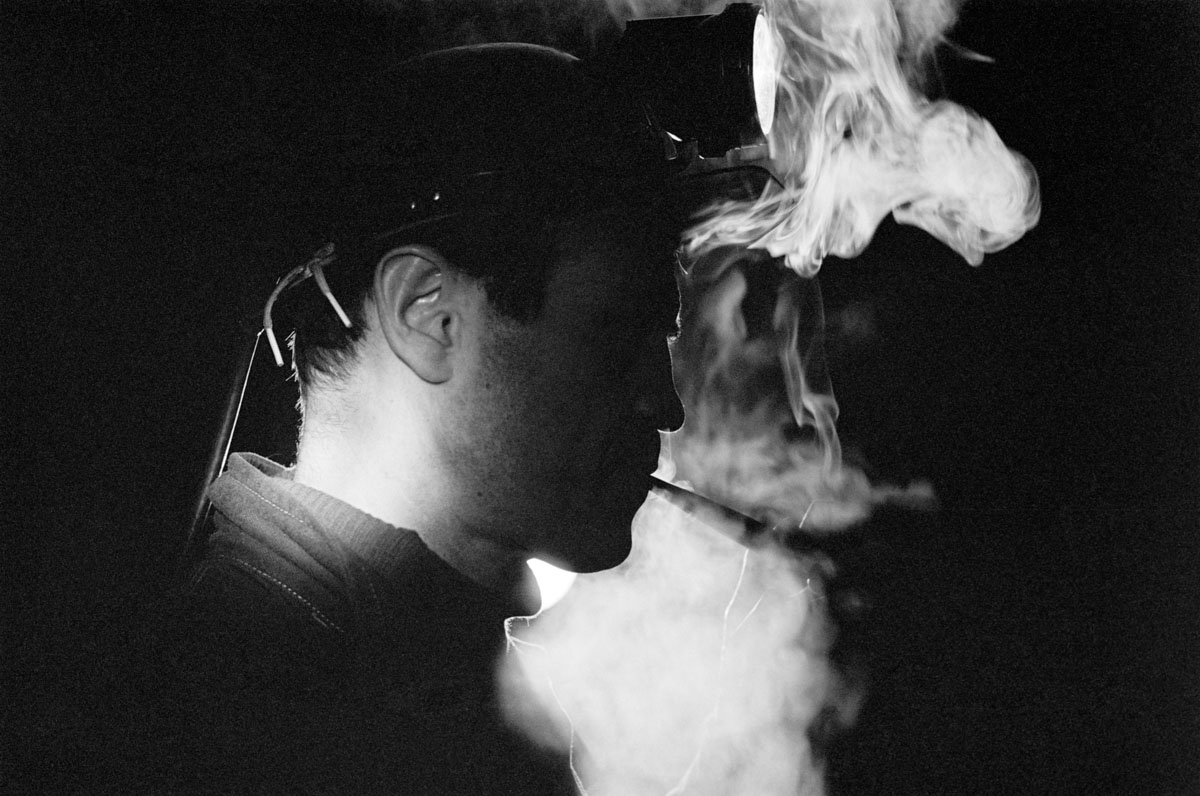miner with a cigarette in his mouth and clouds of smoke