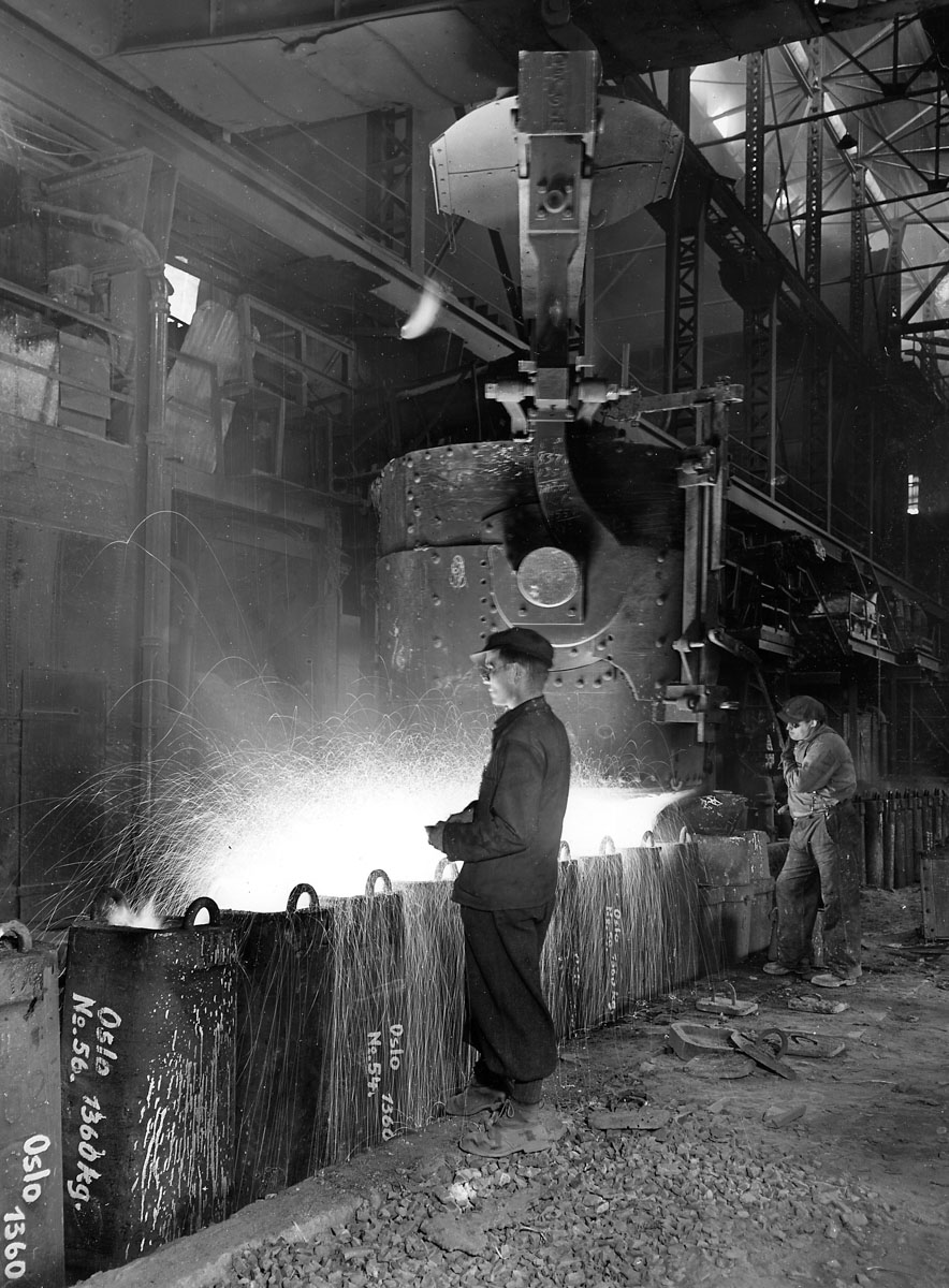 workers at massive cast iron pot
