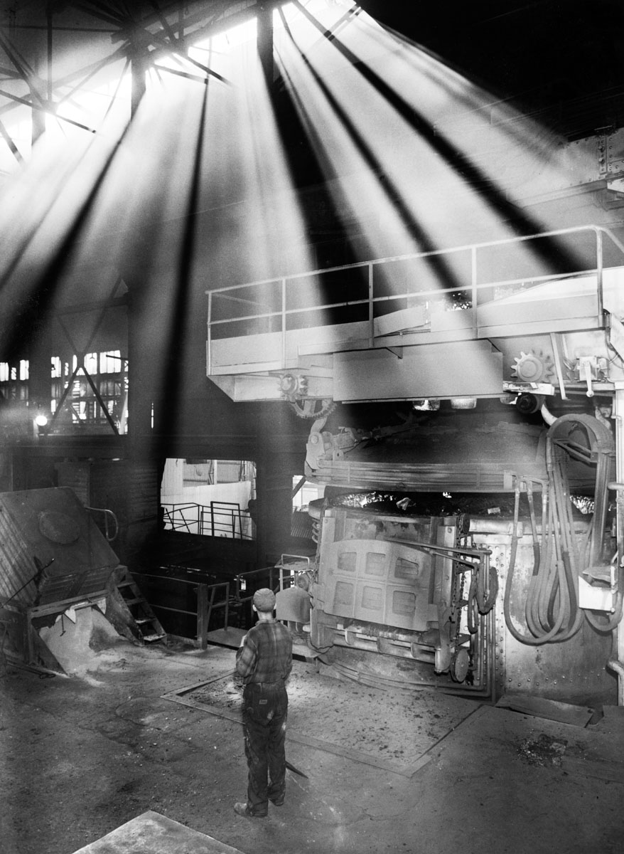 The sun shines on a worker in a factory