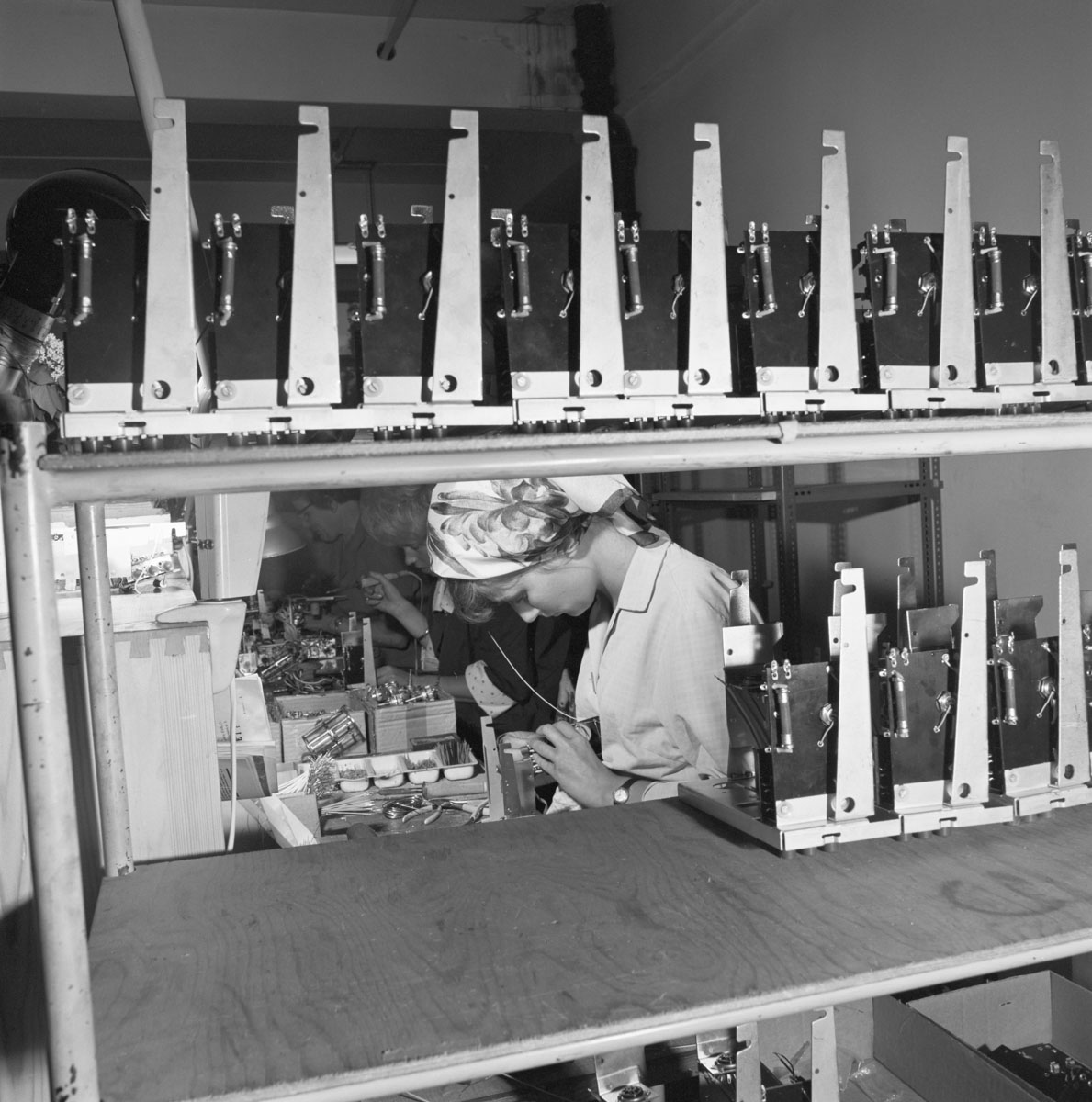 female worker assembling a radio