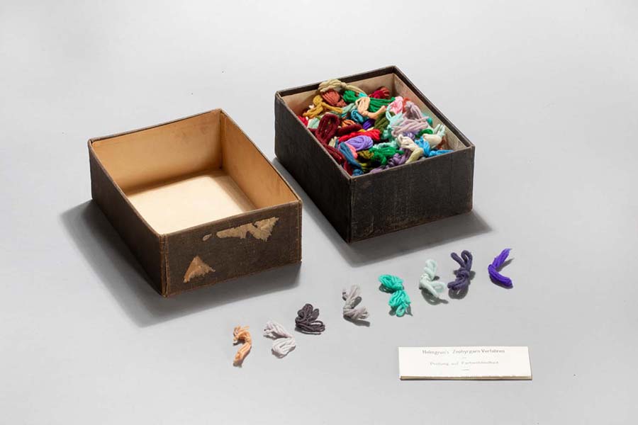 An open box with pieces of string.