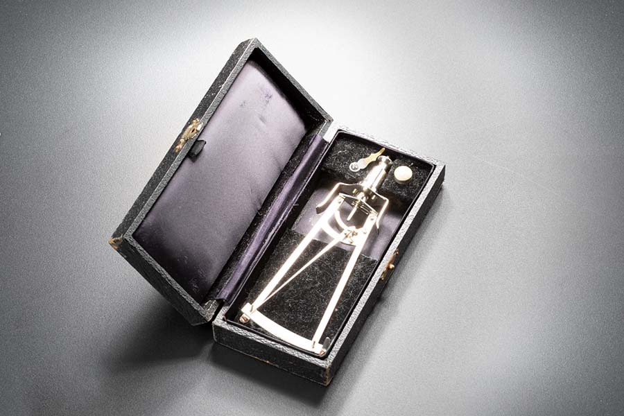 A stainless steel measuring instrument is located in a small box.