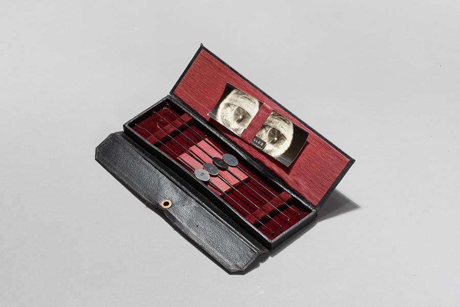 A stainless steel measuring instrument is located in a small box.