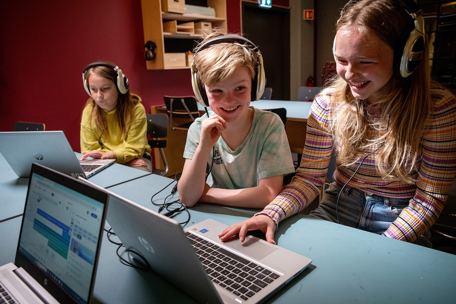 Tre barn med høretelefoner