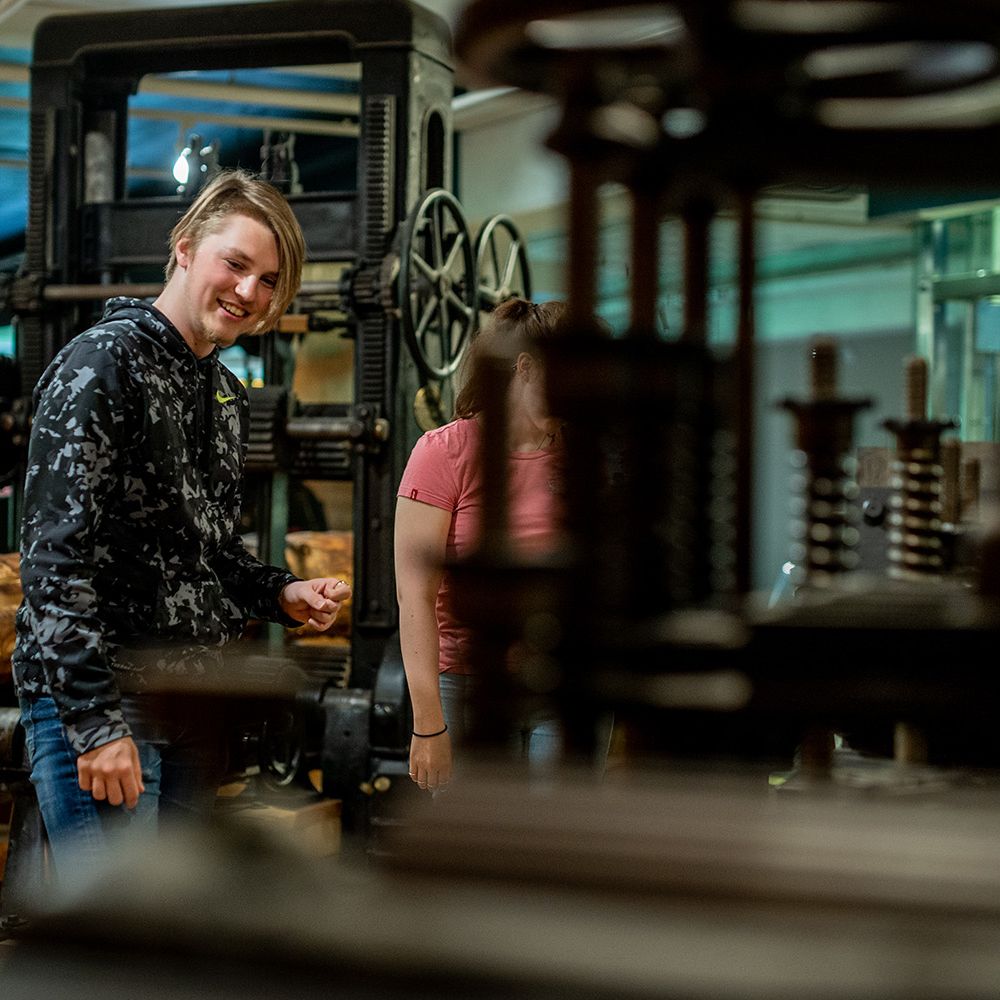 Two young people in the sawmill exhibition