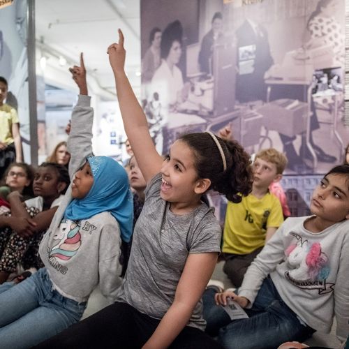 Group of children raising their hands