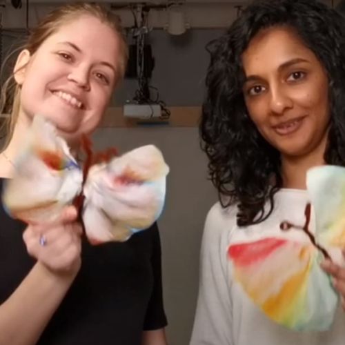 To damer som holder en sommerful lagd av kaffefilter. Foto. 