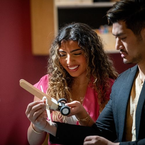 Young man and woman building a robot