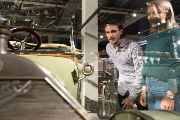 Two adults looking at a retro car