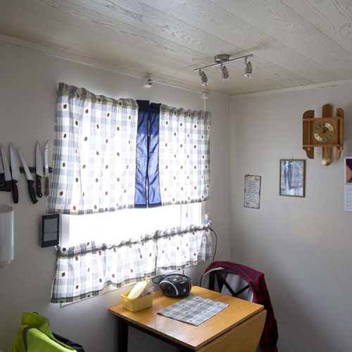 A kitchen table standing next to a window. Photo.