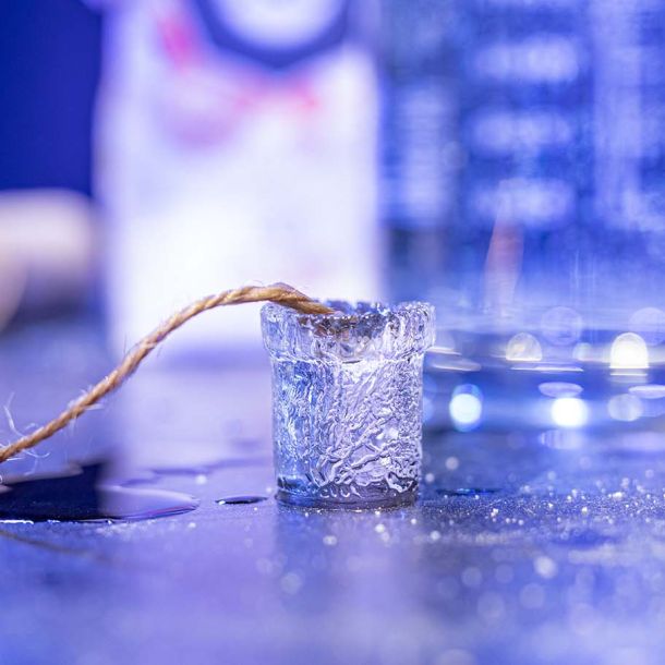 Ice cube with string attached. Photo.