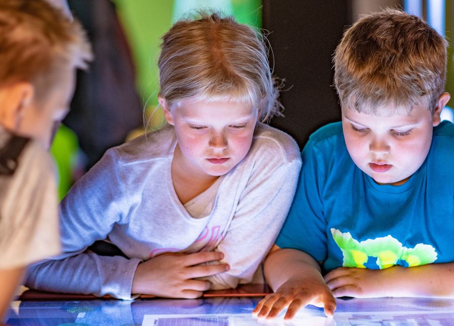 Students on a tour of The Norwegian Museum of Science and Technology , exploring objects and stories related to data and transportation technology throughout the ages.