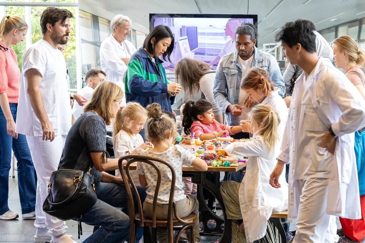 a group of children, doctors and parents during a research trip at the norwegian museum of science and technology in oslo