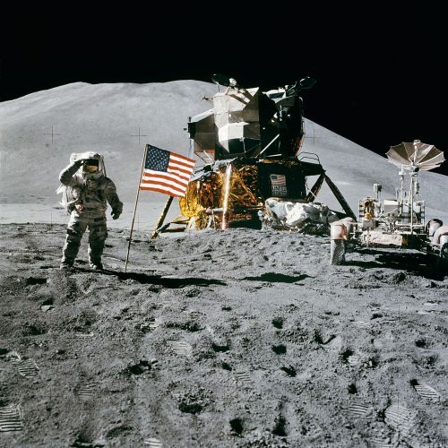 Astronaut stands next to the Lunar Lander on the moon. Photo.