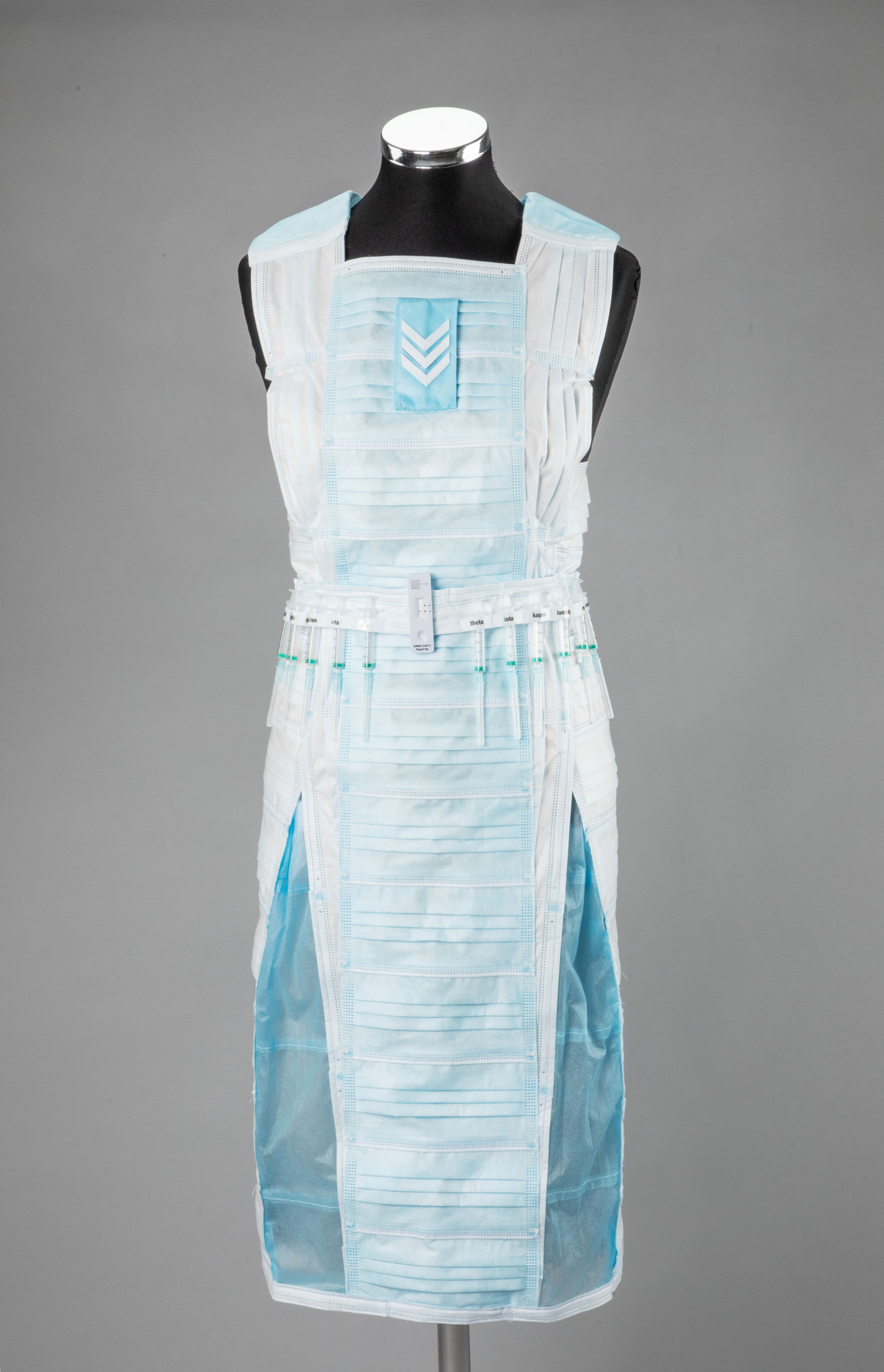 Dress made from face masks hanging on a tailor's bust