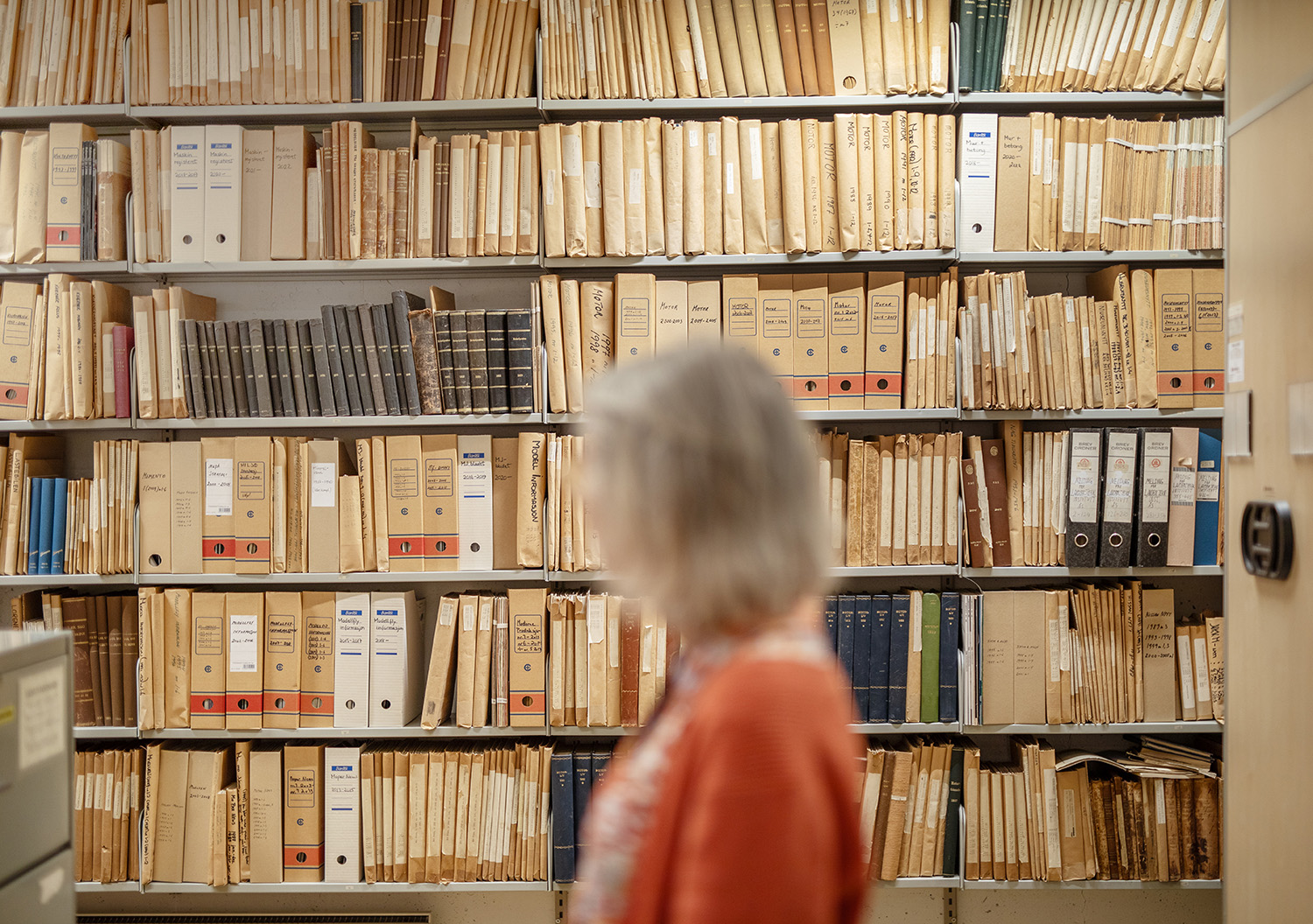 Lady in front of an archive of folders