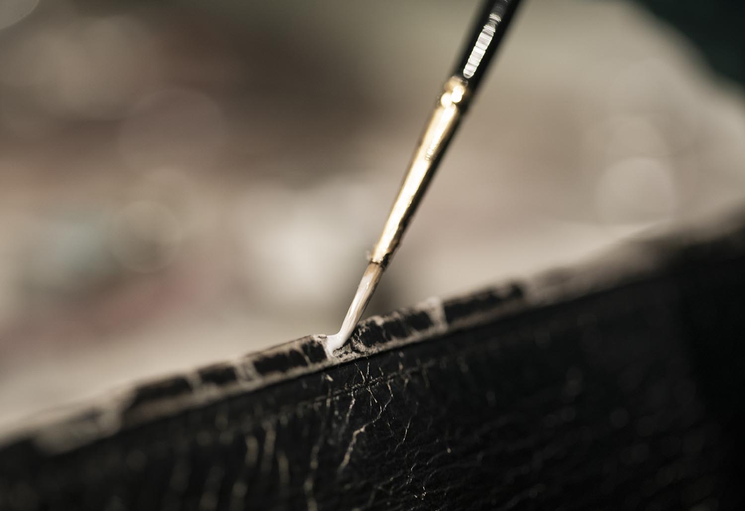 Brush wipes dust from leather