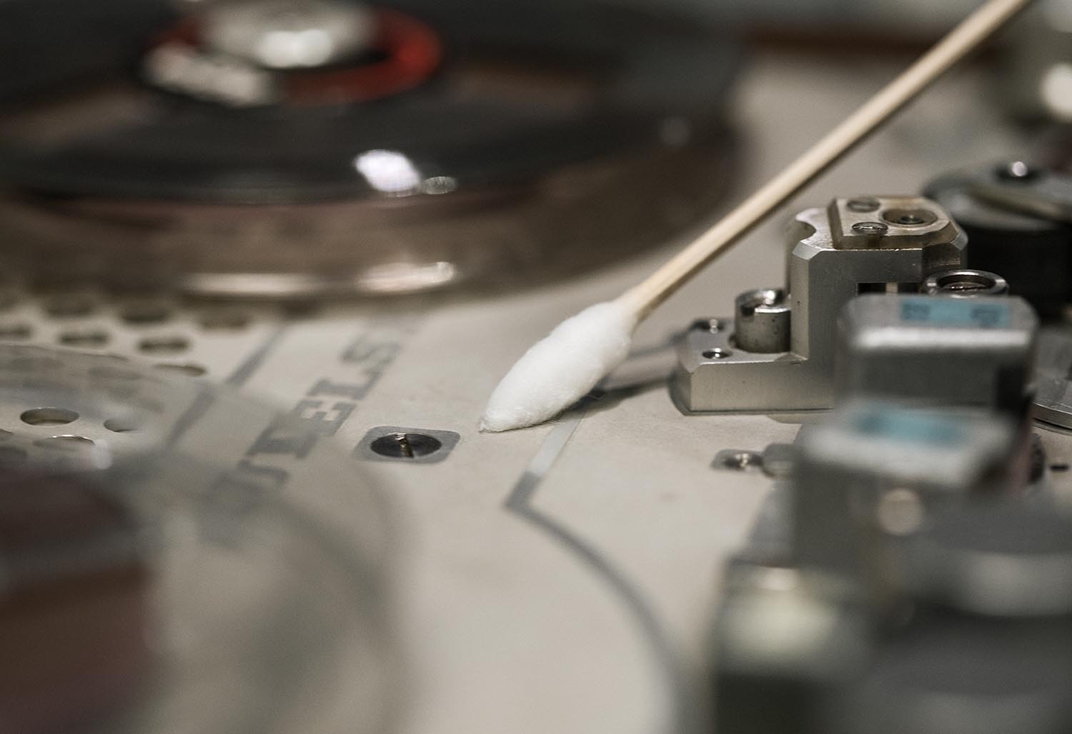 Cotton swab wipes dust from small electronic components