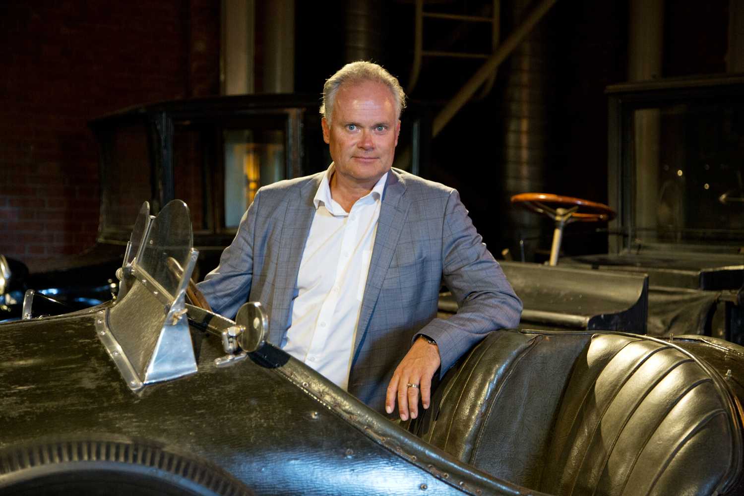 Museum director Frode Meinich sits in an old racing car