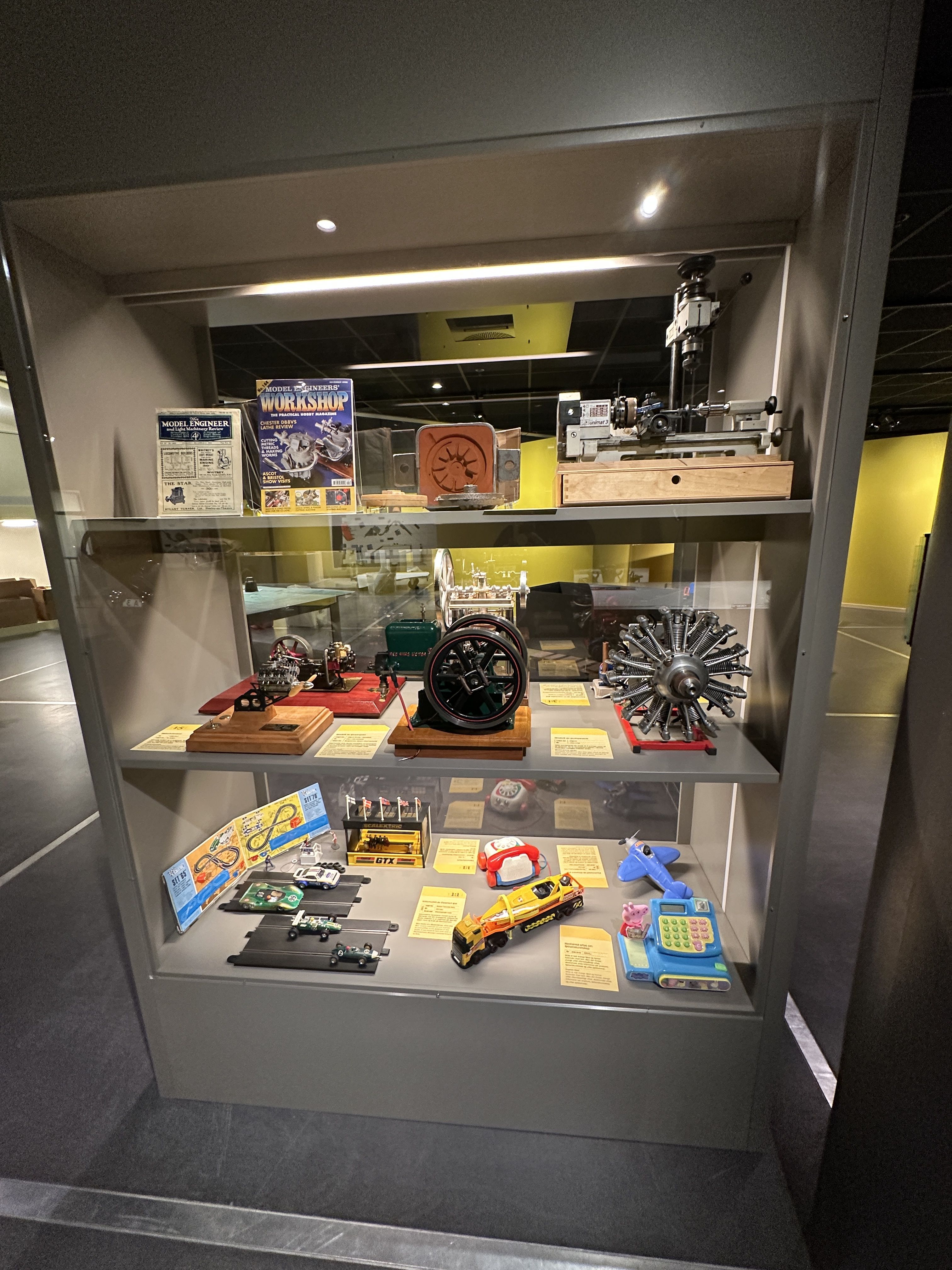 Two sit on a bench and look at the artwork