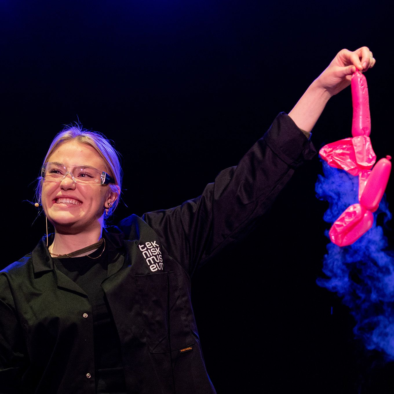 Lady with goggles holding a balloon figure