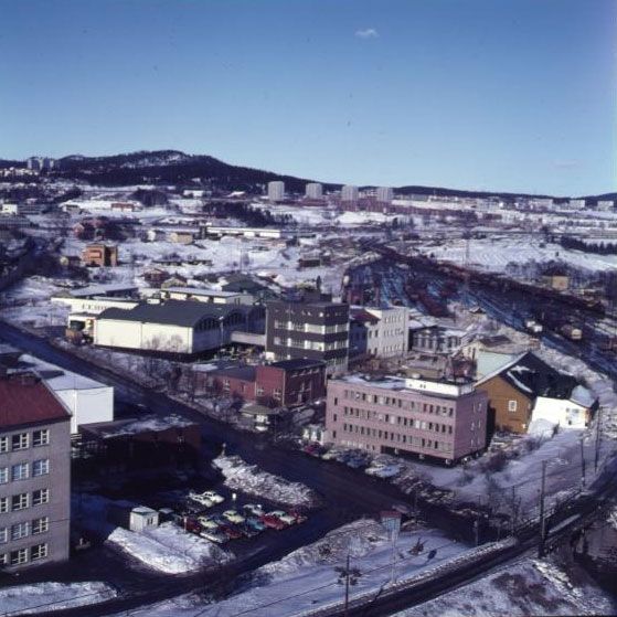 A cityscape with blocks of flats and factories in winter