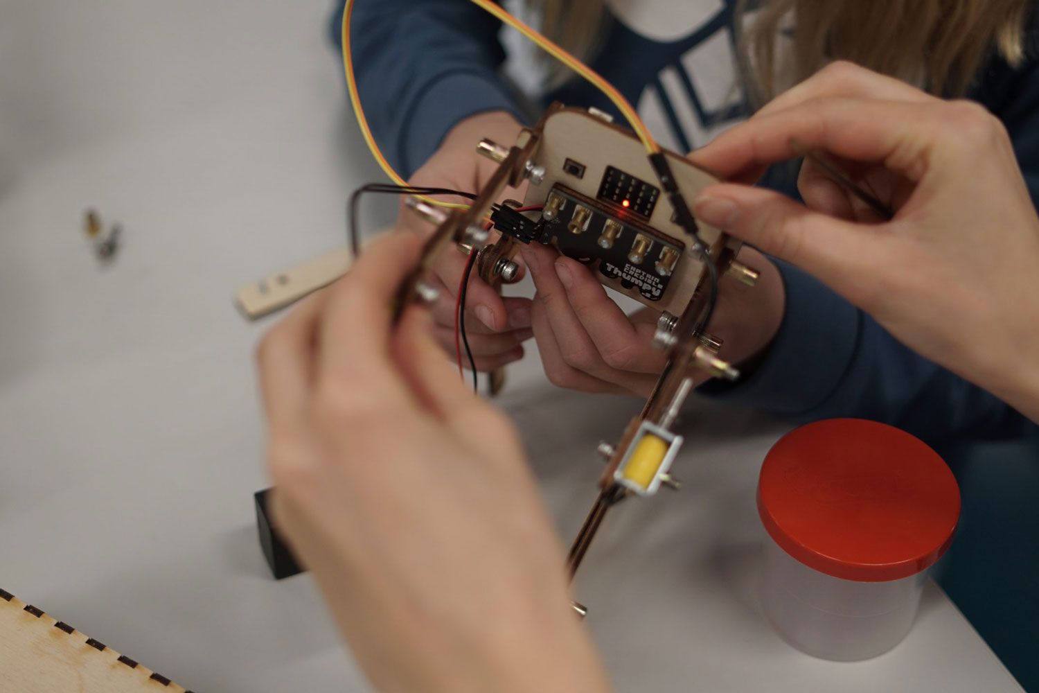 A child in a lab coat who prefers white powder to jumbo test tubes. Photo.  