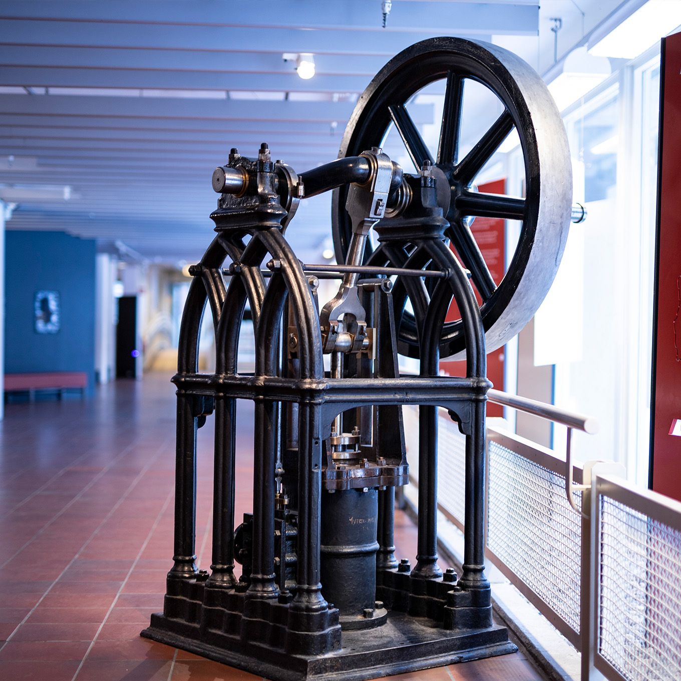A girl in a lab coat raises her hand. Photo.  