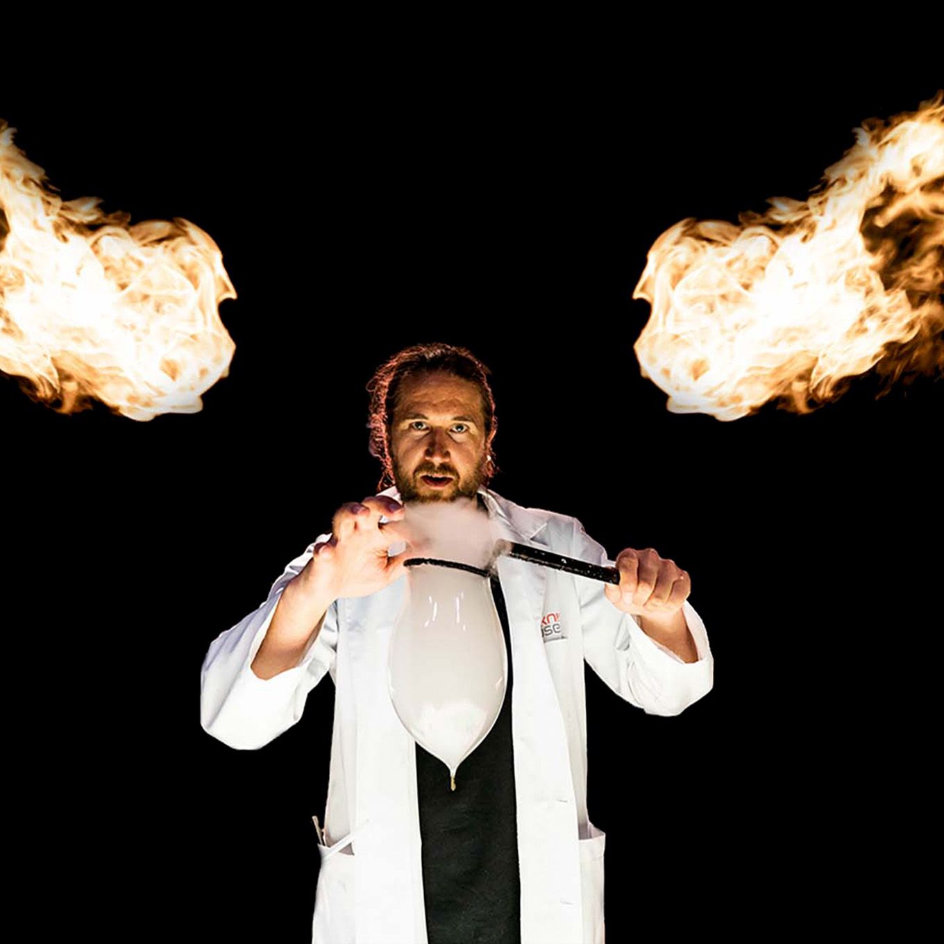 Educator in white coat making a soap bubble with smoke