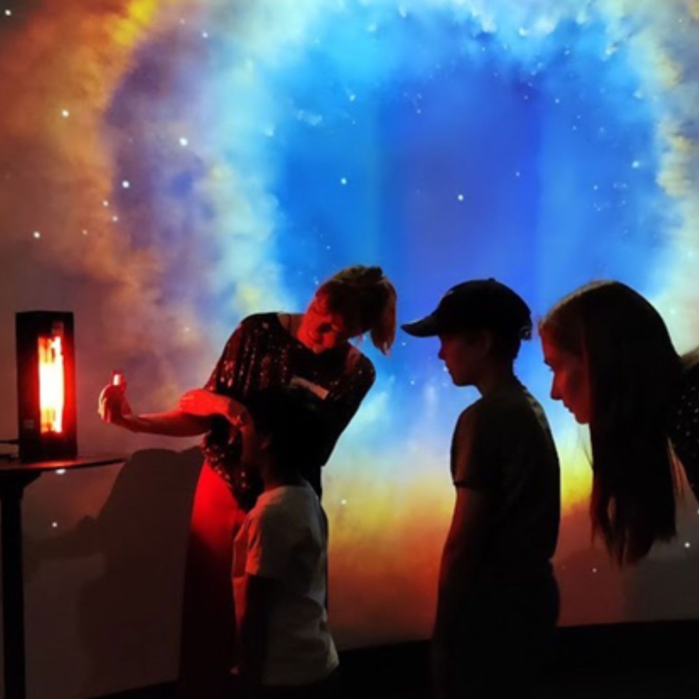 Three people in an astro amphitheater