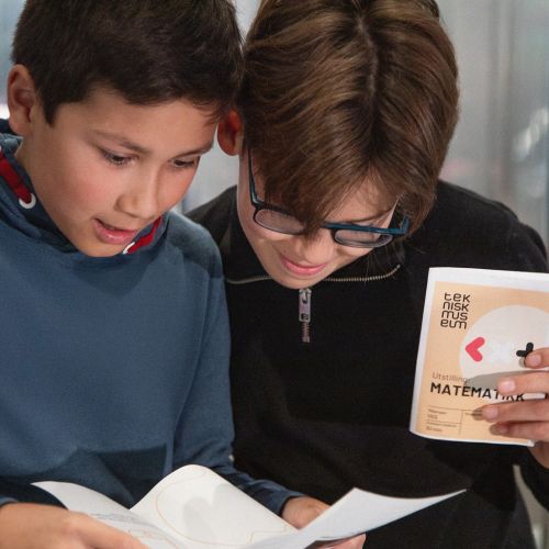 two young boys solve puzzles and explore the norwegian museum of science and technology with learning trails