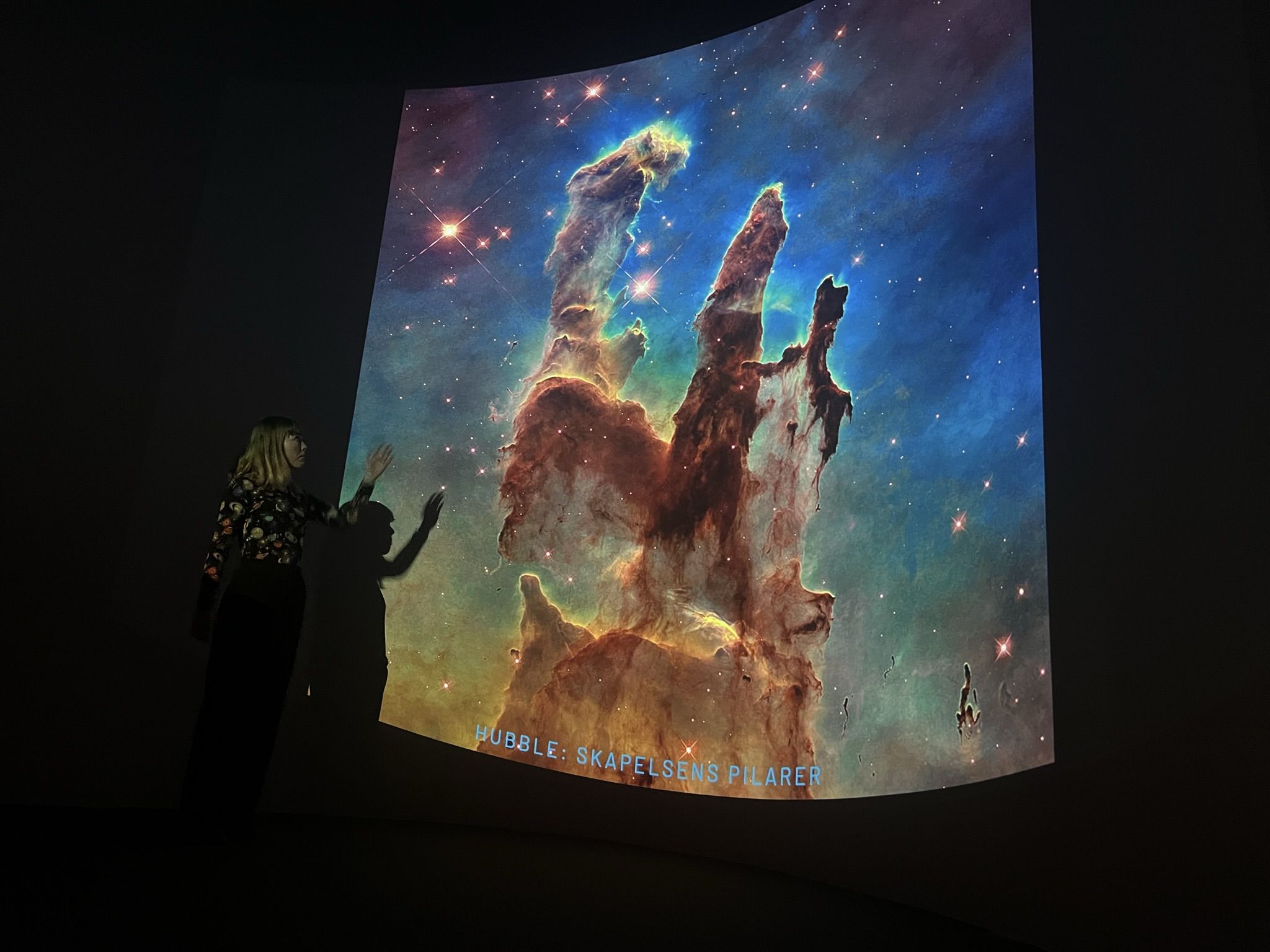 An educator teaches about the Big Bang in the astro amphitheater
